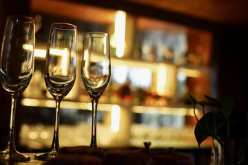 Champagne glasses in a bar background with dark vibes 