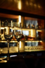 Champagne glasses in a bar background with dark vibes 