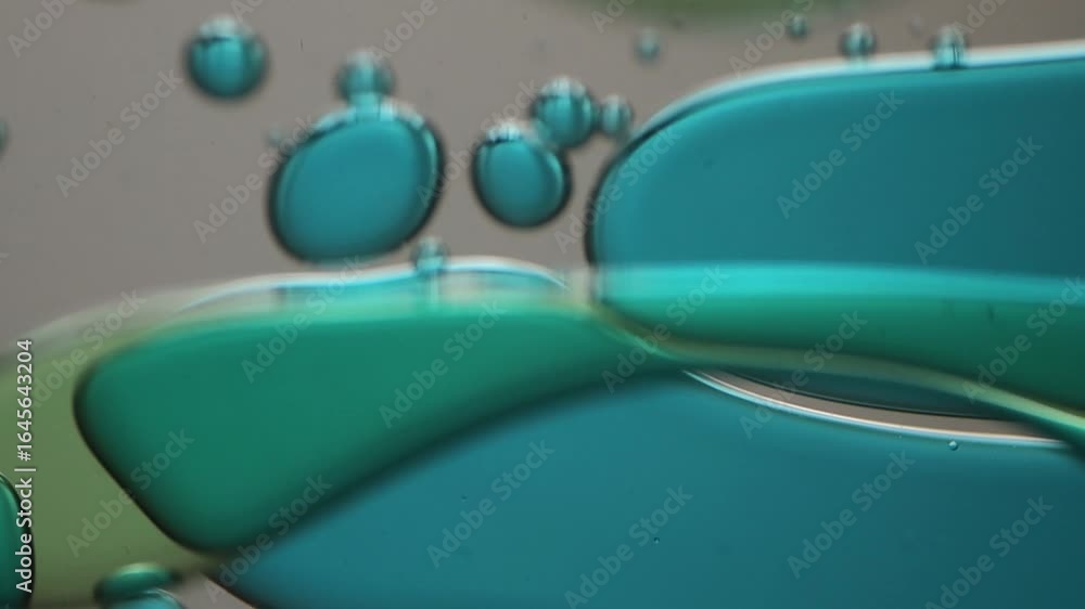 Poster close-up of blue and green liquid with floating bubbles and blobs in motion inside a lava lamp, view