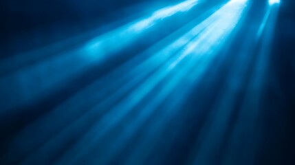 Fototapeta premium Beautiful blue beams of light shining through atmosphere or water