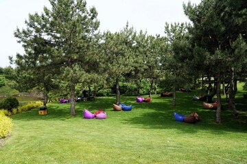 A recreation area outside the city with comfortable poufs on the lawn
