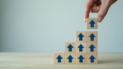 The Path of Growth - A hand placing a wooden block with an upward arrow on a pyramid of blocks, symbolizing a clear path to growth, a business strategy, and development