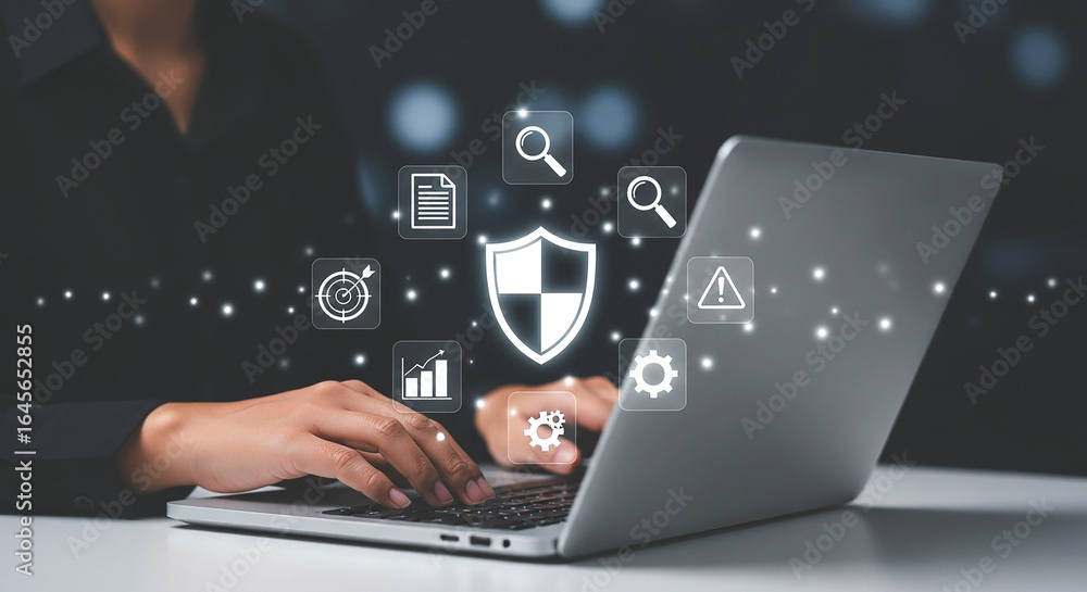 Poster person using laptop with security shield and other icons floating above the keyboard area view