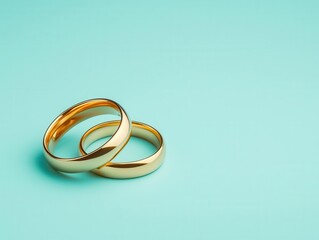 Fototapeta premium Classic matching yellow gold wedding bands with domed profiles, isolated on a pastel blue background