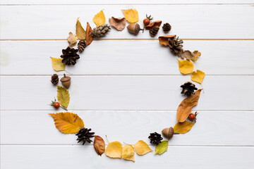 Autumn composition made of dried leaves, cones and acorns on table. Flat lay, top view