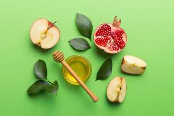Flat lay composition with symbols jewish Rosh Hashanah holiday attributes on colored background,...