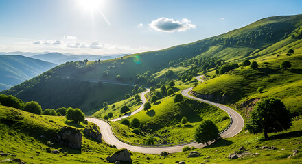Winding mountain road through lush green hills under a bright sunny sky