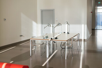 Empty modern study or coworking area with sleek furniture and ample natural light. A minimalist...