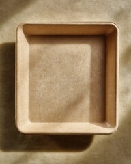 Minimalist square baking dish on neutral surface, ideal for culinary photography and kitchen decor inspiration