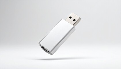 A close-up studio shot of a silver USB flash drive, isolated on white.