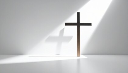 Naklejka premium A simple wooden cross stands illuminated by a single beam of light in a stark white room, casting a distinct shadow.