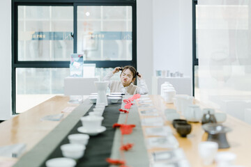 Young girl in a tea house showing playful expressions at a wooden table Chinese word means tea.