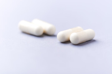 Creatine tablets on paper background. Soft focus. Close up. Copy space.	