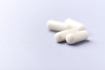 Creatine tablets on paper background. Soft focus. Close up. Copy space.	