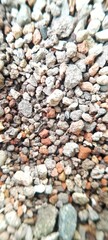 A stretch of small gravel rocks of various shapes and colors