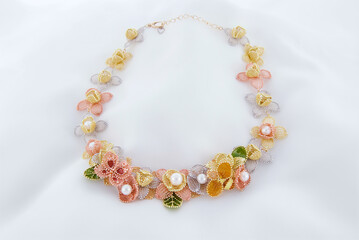 Elegant fine jewelry necklace featuring gold, silver, and pearl floral elements, ideal for bridal, luxury fashion, and versatile formal wear styling.