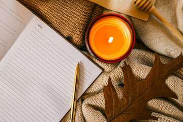 Cozy autumn scene with an open lined notebook labeled 