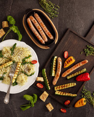 grilled sausages zucchini bell peppers cherry tomato pasta herbs parmesan roasted vegetables rustic...