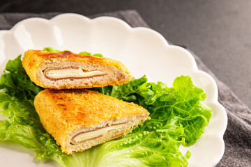 Cutlet cordon bleu meat chicken, cheese, ham second course french cuisine tasty snack fresh delicious gourmet food background on the table rustic food top view copy space
