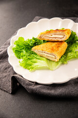 Cutlet cordon bleu meat chicken, cheese, ham second course french cuisine tasty snack fresh delicious gourmet food background on the table rustic food top view copy space