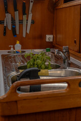 Interior of a Boat Galley with Wooden Cabinets and Stainless Steel Sink
