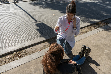 Doctor assisting sick woman on sidewalk
