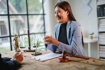 Lawyer smiling and discussing contract details with client in office