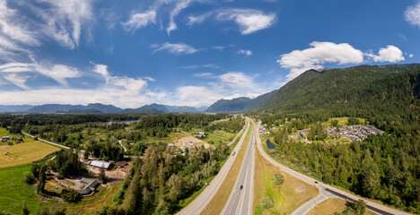 Aerial View of Fraser Valley Highway Through Forested Mountains and Farmland