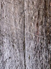 Old weathered brown wooden wall with rough texture and natural wood grain pattern