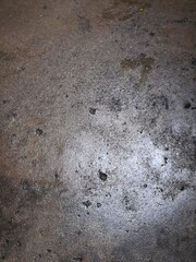 A gray footprint in the sand with a rough, textured, grunge pattern of old concrete and rock