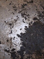 A gray footprint in the sand with a rough, textured, grunge pattern of old concrete and rock