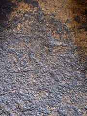 A gray footprint in the sand with a rough, textured, grunge pattern of old concrete and rock