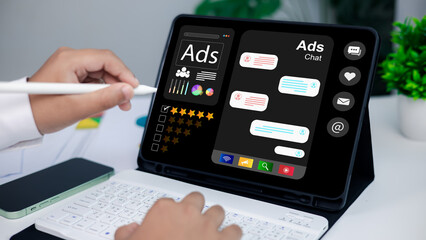 Digital marketing, social media advertising, and customer engagement. Close-up of hands using stylus on tablet with online ads dashboard and chat interface.