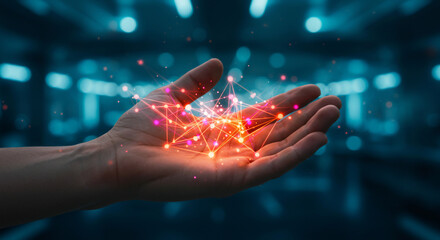 A hand holds a glowing network of interconnected nodes, symbolizing technology, connection, and innovation against a blurred blue background.