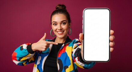 Smiling young woman pointing to blank smartphone screen – mockup space for app, website, or marketing design