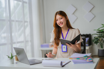 Obraz premium Asian businesswoman working with calculator and laptop in office