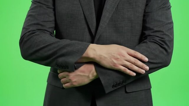 Close-up of Professional Businessman's Hands Crossing and Uncrossing on Green Screen