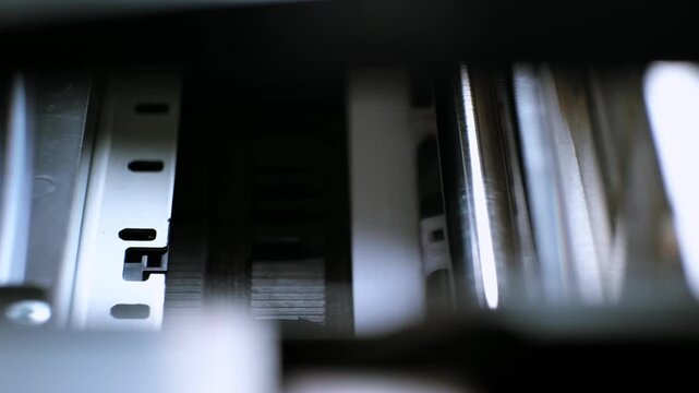 The process of printing a color inkjet printer in close-up. The rolles is rolling inside of device and printed a picture. A color calibration test. Print color chart for spectrophotometer. 4k footage.