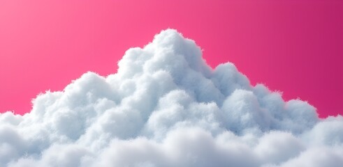 Fototapeta premium Fluffy white cloud formation against a vibrant pink sky