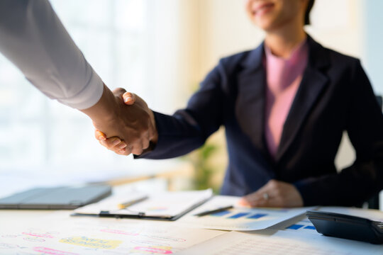 Business people shaking hands, closing a deal after successful meeting