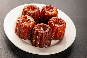 Canneles sweet dessert french cuisine sweets fresh delicious gourmet food background on the table rustic food top view copy space