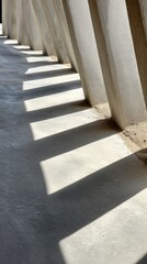 Abstract shadows of architectural supports on concrete floor