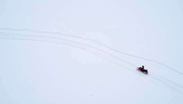 Snowmobiler carving through pristine snowfield, winter adventure - Powered by Adobe