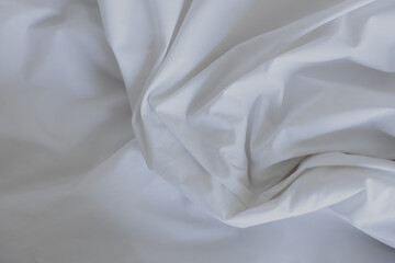 Abstract white fabric background. Elegant and soft material with wavy folds and a smooth texture. Copy space