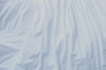 Fototapeta premium Abstract white fabric background. Elegant and soft material with wavy folds and a smooth texture. Copy space