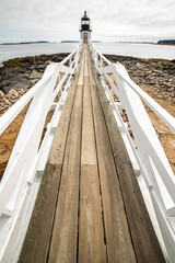 lighthouse on wooden pier 