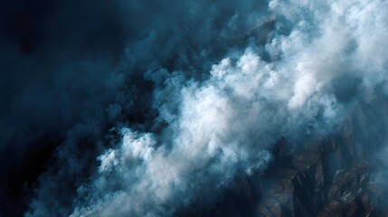 Fototapeta premium Aerial view of a raging forest fire with thick smoke spreading across the landscape