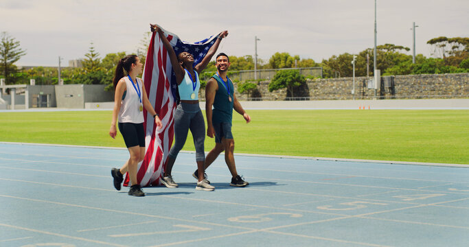Woman, winner and USA flag on track for competition, excited or success with goal at global sports event. Girl, athlete and champion with national pride, people and contest at stadium in summer