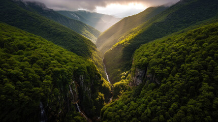 Lush green mountains with cascading waterfalls create breathtaking landscape, showcasing beauty of nature. Sunlight filters through valleys, illuminating serene environment