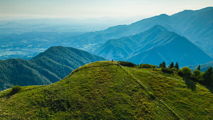 Aerial panoramic view of Velika Planina in Slovenia featuring vast green alpine pastures dotted...